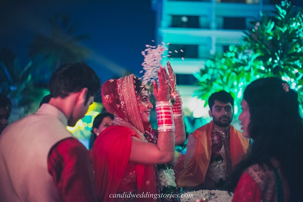 bride throws rice at her Bollywood themed destination Goa wedding