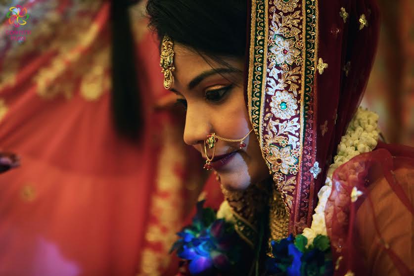 Beautiful Indian bride in red gold lehenga choli with zari border
