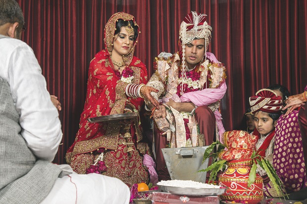 red lehenga real bride Gurgaon Leela Kempinski