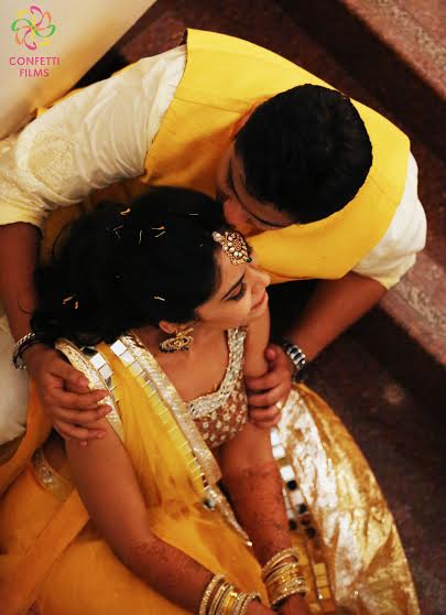 Indian bride and groom at their Sangeet ceremony in yellow colour outfits