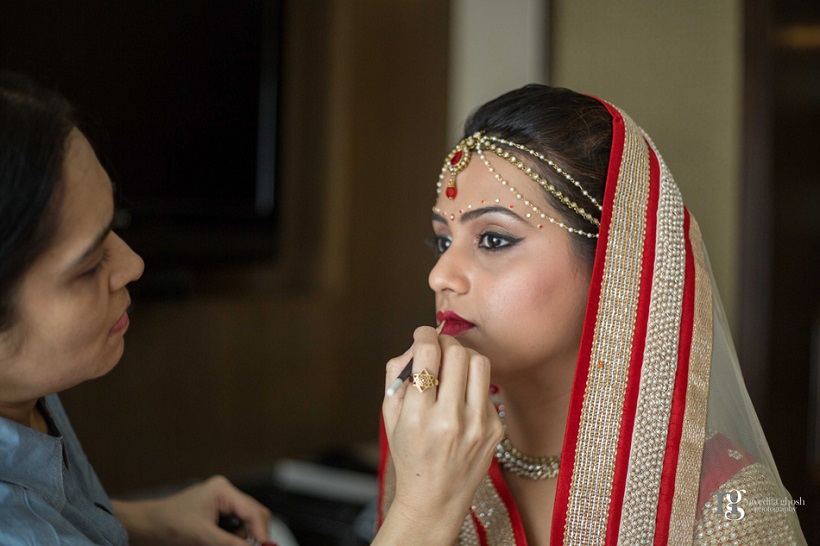bride gets made up at her bride at her wedding Club Millennium by Nivedita Ghosh Photography